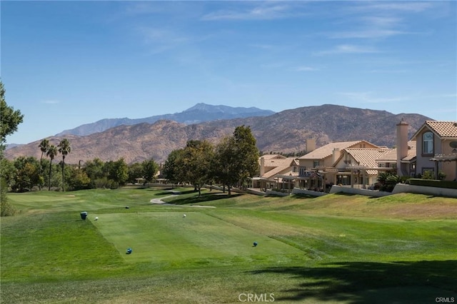 view of community with a mountain view and a lawn