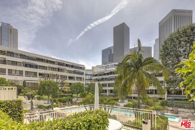 view of building exterior featuring a community pool