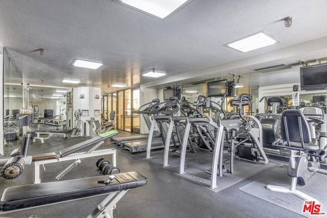 workout area featuring a textured ceiling