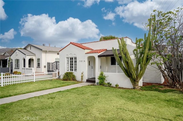 mediterranean / spanish home featuring a front lawn