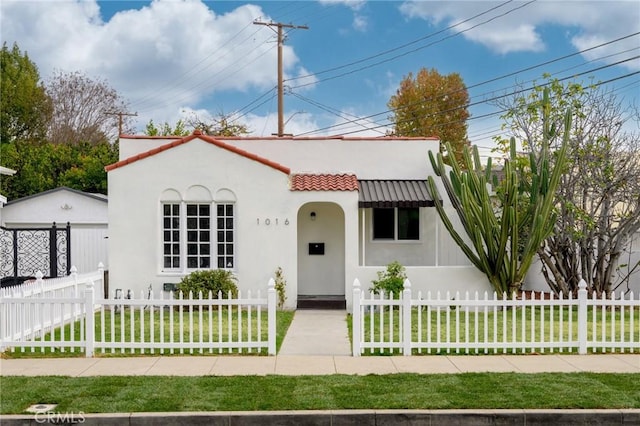 mediterranean / spanish-style home with a front yard