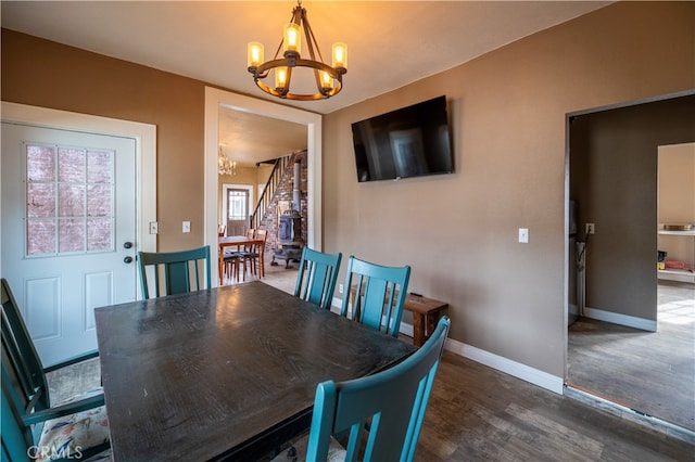 dining space featuring a chandelier, a wealth of natural light, and dark wood-type flooring