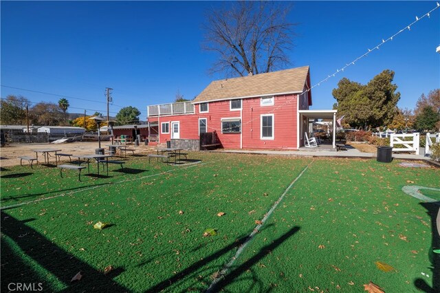 rear view of property featuring a patio