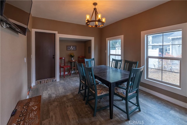 dining room with a chandelier and dark hardwood / wood-style flooring