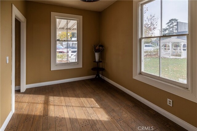 unfurnished room with hardwood / wood-style floors