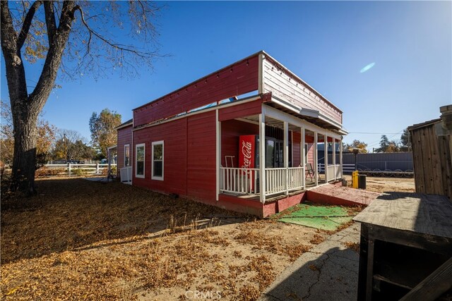 view of side of property with covered porch