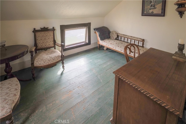 living area with hardwood / wood-style floors and vaulted ceiling