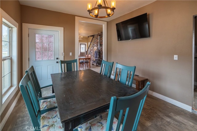 dining space featuring dark hardwood / wood-style floors and a chandelier