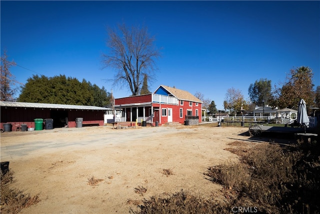 rear view of house featuring an outbuilding