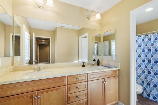 bathroom featuring vanity and toilet