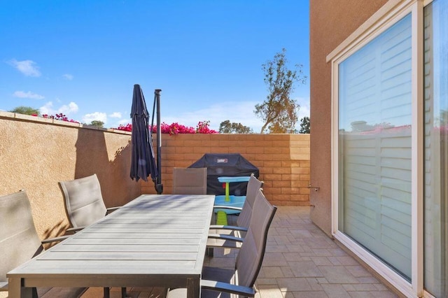 view of patio featuring a grill