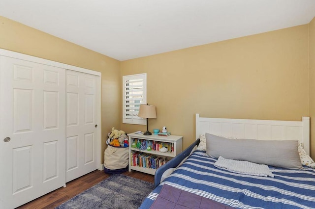 bedroom featuring dark hardwood / wood-style floors and a closet