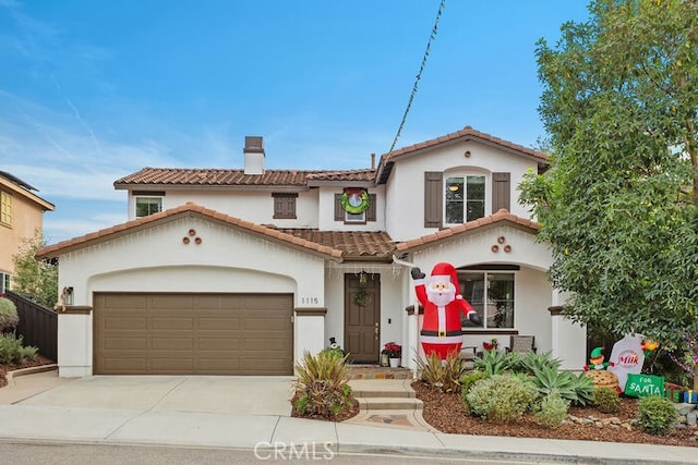 mediterranean / spanish-style home with a garage