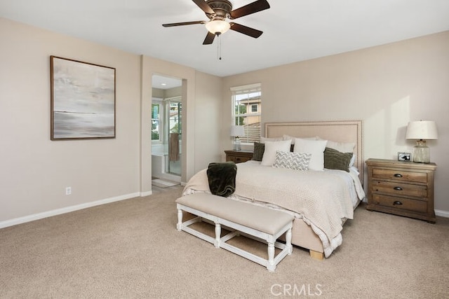 carpeted bedroom with connected bathroom and ceiling fan