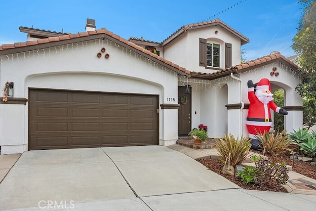 mediterranean / spanish house featuring a garage