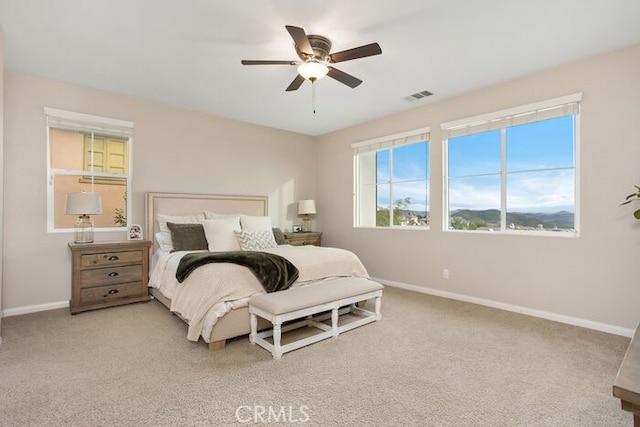 bedroom featuring light carpet and ceiling fan