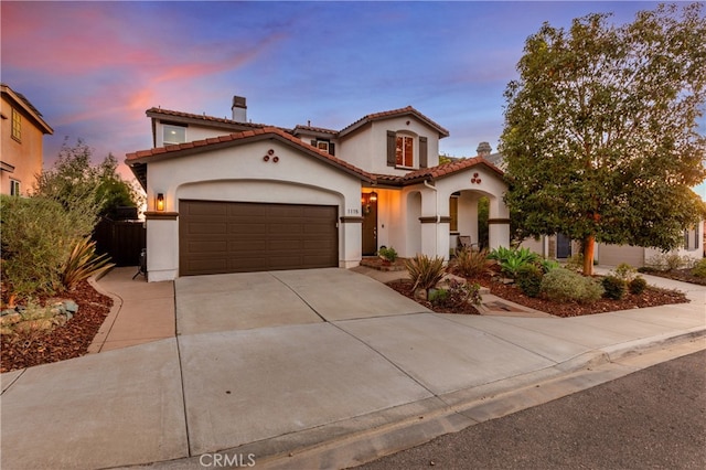 mediterranean / spanish-style home featuring a garage