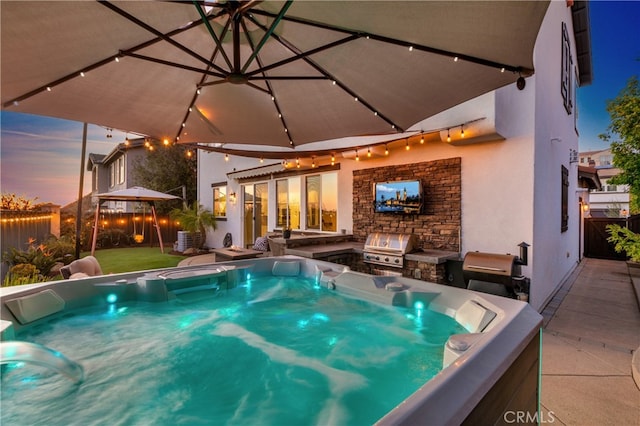 pool at dusk featuring area for grilling, a gazebo, grilling area, and a patio area