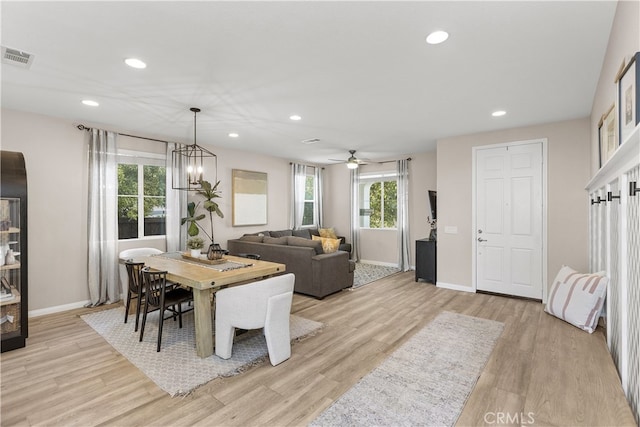 dining space with an inviting chandelier and light hardwood / wood-style flooring