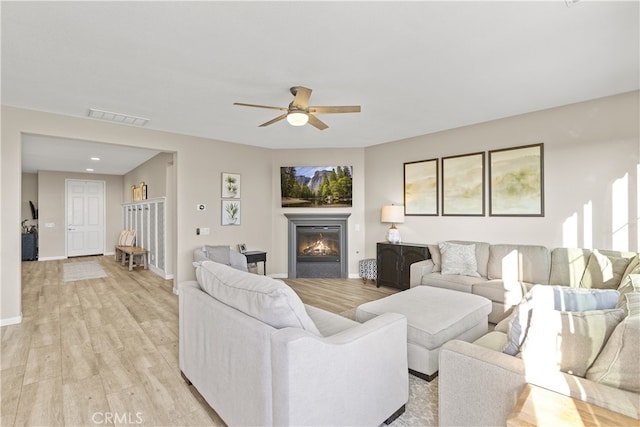 living room featuring ceiling fan and light hardwood / wood-style floors