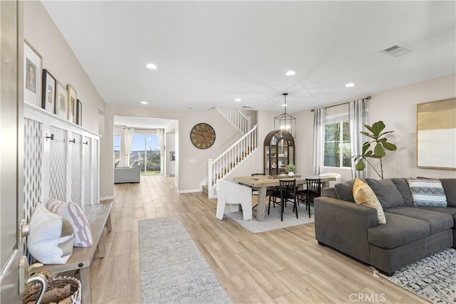 living room featuring a wealth of natural light and light hardwood / wood-style floors