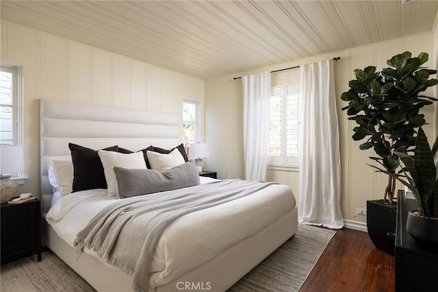 bedroom with dark hardwood / wood-style floors