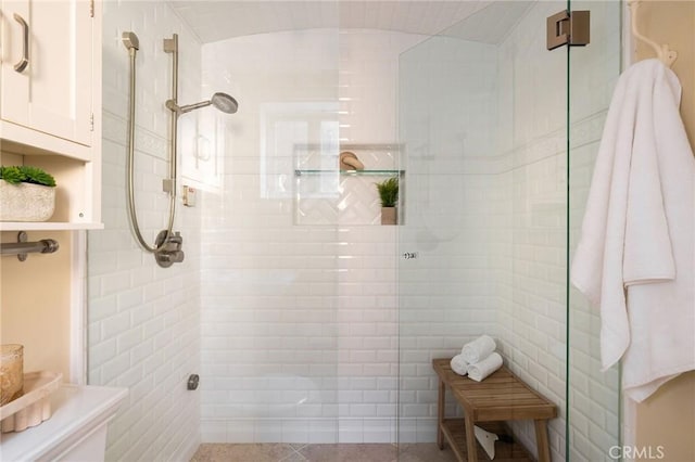 bathroom featuring tile patterned flooring and walk in shower