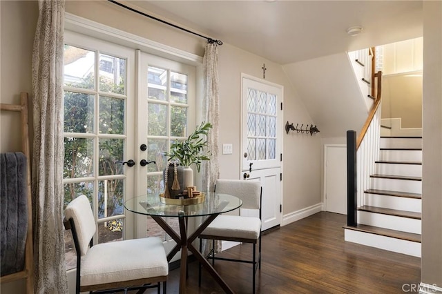 dining area featuring lofted ceiling and dark wood-type flooring