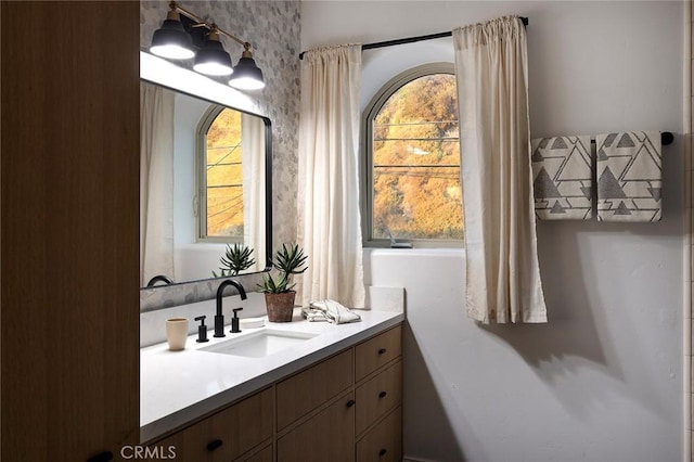 bathroom with plenty of natural light and vanity