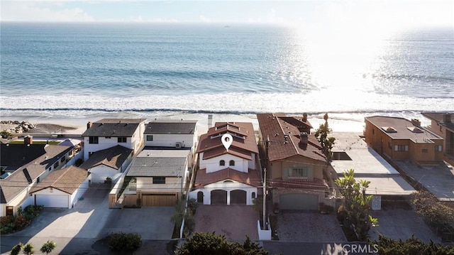 bird's eye view featuring a water view and a view of the beach