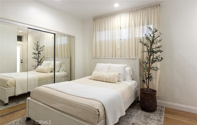 bedroom featuring hardwood / wood-style floors and a closet