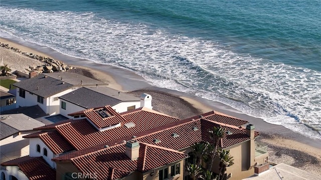 drone / aerial view featuring a water view and a beach view