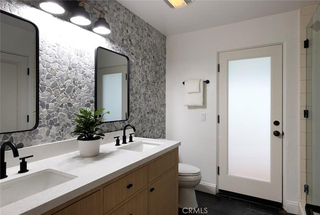 bathroom featuring vanity, toilet, and a shower with door