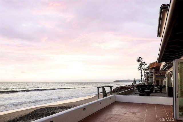 exterior space with a water view and a view of the beach