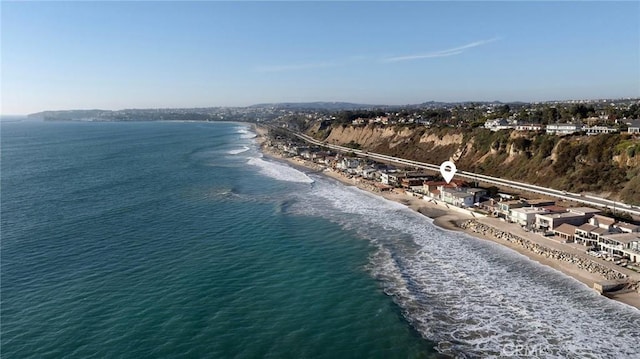 drone / aerial view featuring a water view and a view of the beach