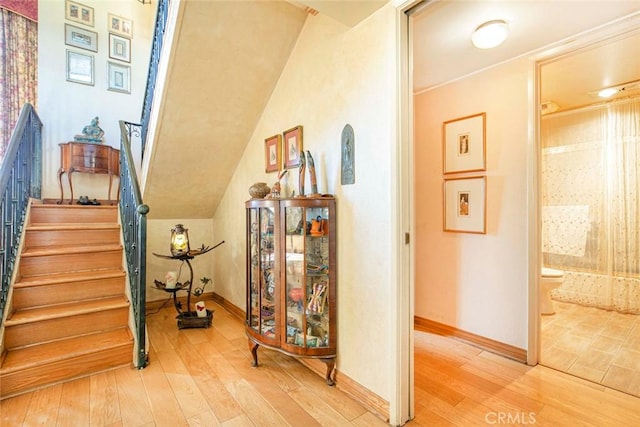 interior space featuring hardwood / wood-style floors and vaulted ceiling