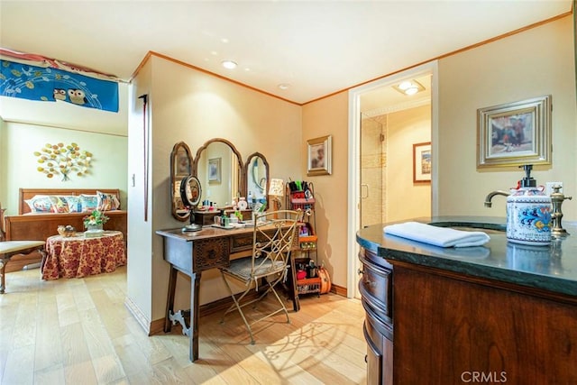 bathroom with vanity, wood-type flooring, and ornamental molding