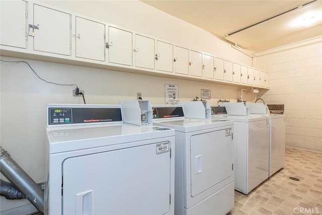 clothes washing area with washing machine and dryer