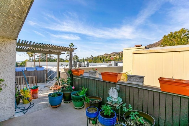 view of patio / terrace featuring a pergola and a hot tub