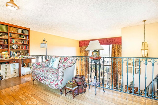 sitting room featuring hardwood / wood-style flooring and a textured ceiling