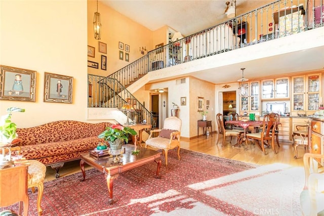 living room featuring a high ceiling and wood-type flooring