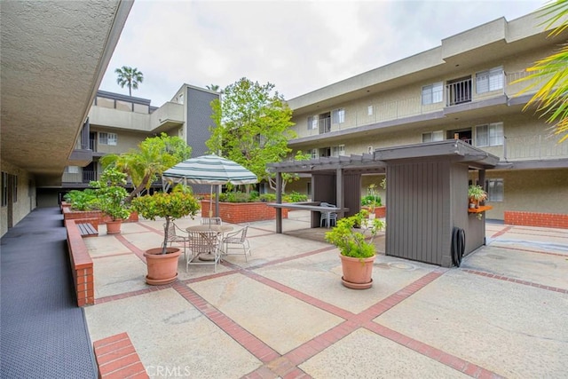 surrounding community with a pergola and a patio area