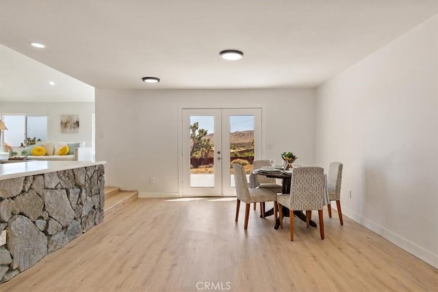 dining area featuring french doors and light hardwood / wood-style flooring