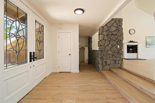 corridor with light hardwood / wood-style floors