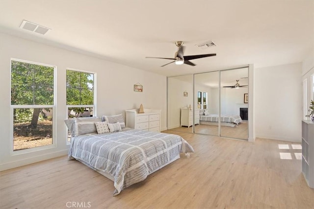 bedroom with ceiling fan, hardwood / wood-style floors, and a closet