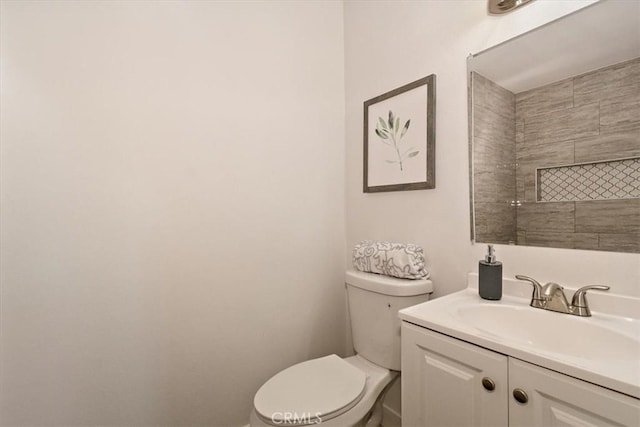 bathroom featuring toilet and vanity