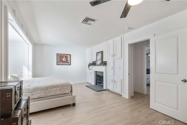 bedroom with ceiling fan and light hardwood / wood-style flooring