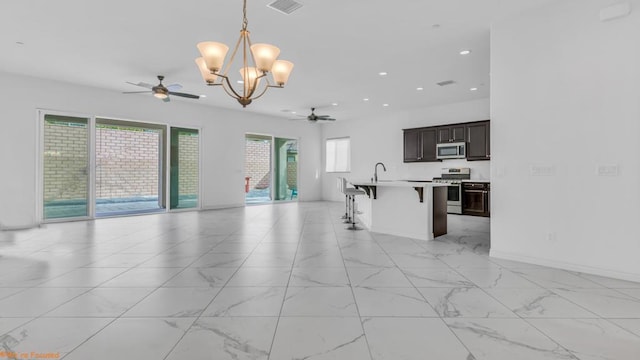 kitchen with a kitchen breakfast bar, a wealth of natural light, hanging light fixtures, and stainless steel appliances