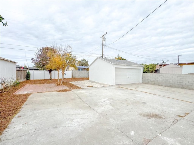 view of patio featuring a garage and an outbuilding