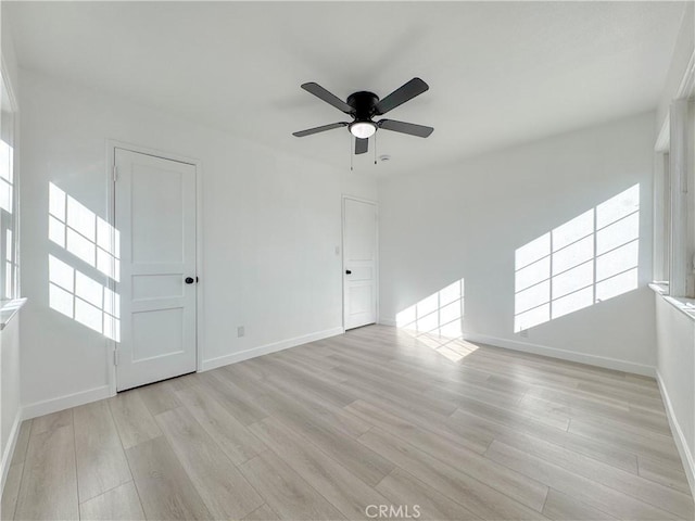 spare room with ceiling fan and light hardwood / wood-style flooring